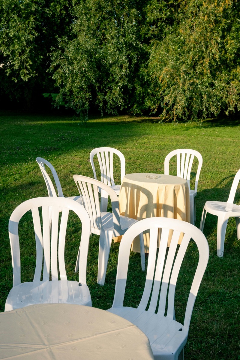 Tables and chairs setup alongside bounce house rental